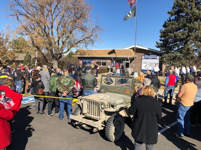 A shot of the crowd at the 2020 Veterans Memorial Day event at the Broomfield Veterans Memorial Museum, November 11, 2020. Many of the attendees are shown wearing masks and distancing as the flag is raised.