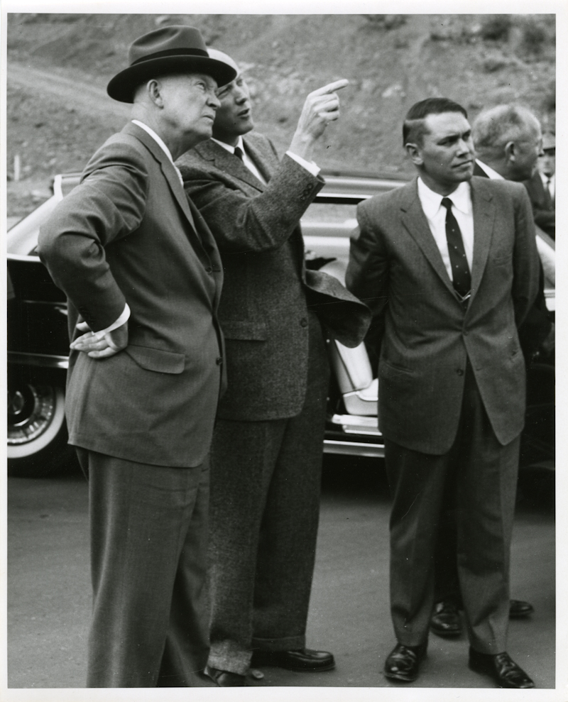 President Eisenhower stands with Martin Company representatives and advisors while observing a missile test.