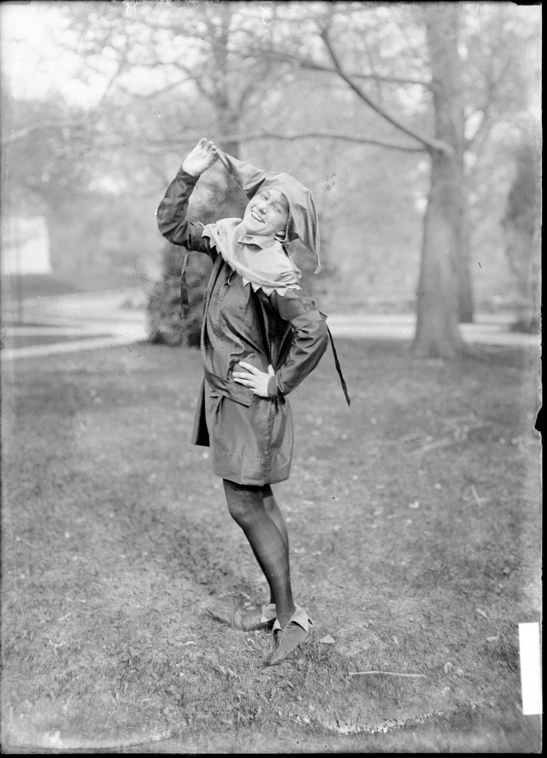 A woman dressed as a jester in a vintage Halloween photograph.