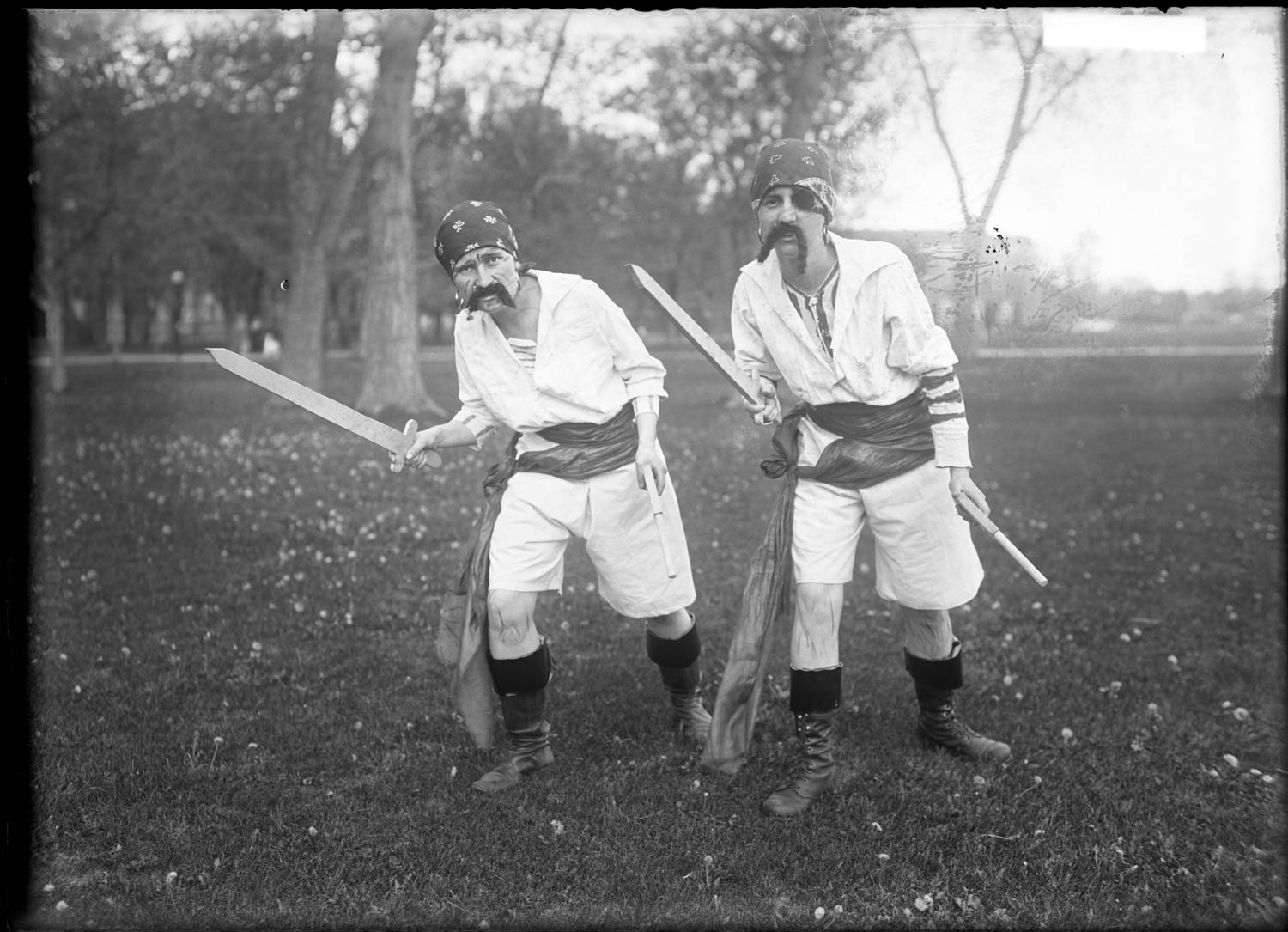 Two young women dressed as pirates in a vintage Halloween photograph.