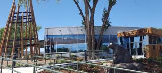 Front of the Ute Indian Museum, with teepee and large tree. A ramp goes up to the front door.