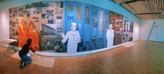 Artist Adri Norris making progress on the Five Points Plus exhibit mural.
