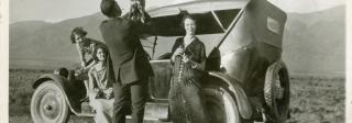 Mister Pimp Powers being held up by a man while Laura Evans, second from left, watches.