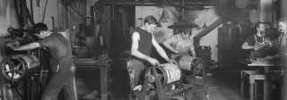 Men working with type on rollers in the printing room of the Rocky Mountain News, 1900s-1910s.