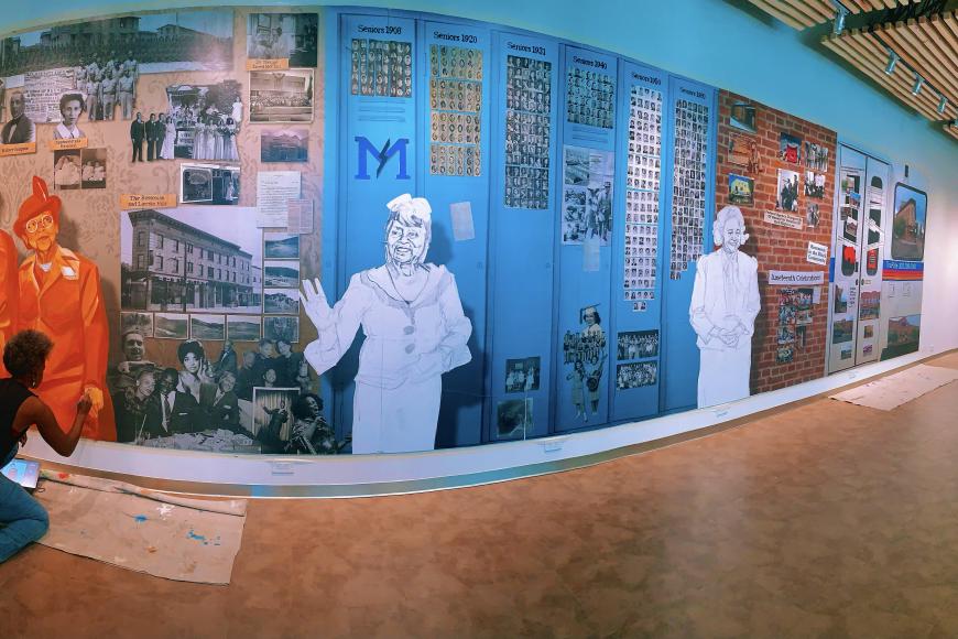 Artist Adri Norris making progress on the Five Points Plus exhibit mural.