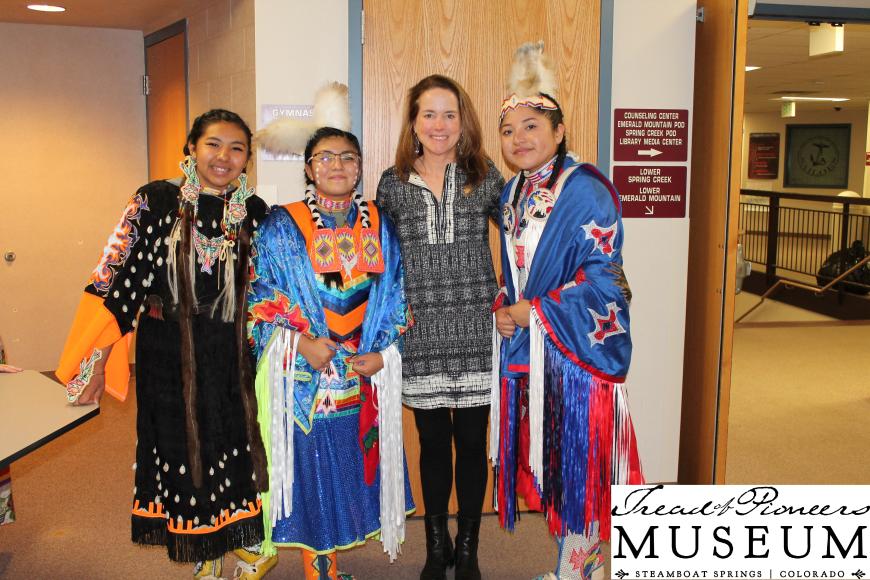 4 women in regalia posing in the Tread of Pioneers museum.