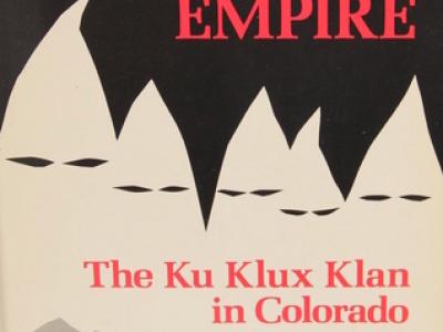 Image of the cover of the book, Hooded Empire: The Ku Klux Klan in Colorado, by Robert Alan Goldberg. The background is black and there is a silhouette of five hoods with eye holes, which also somewhat suggest the mountains of the Front Range.